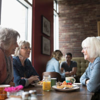 Seniors enjoy breakfast in a cafe
